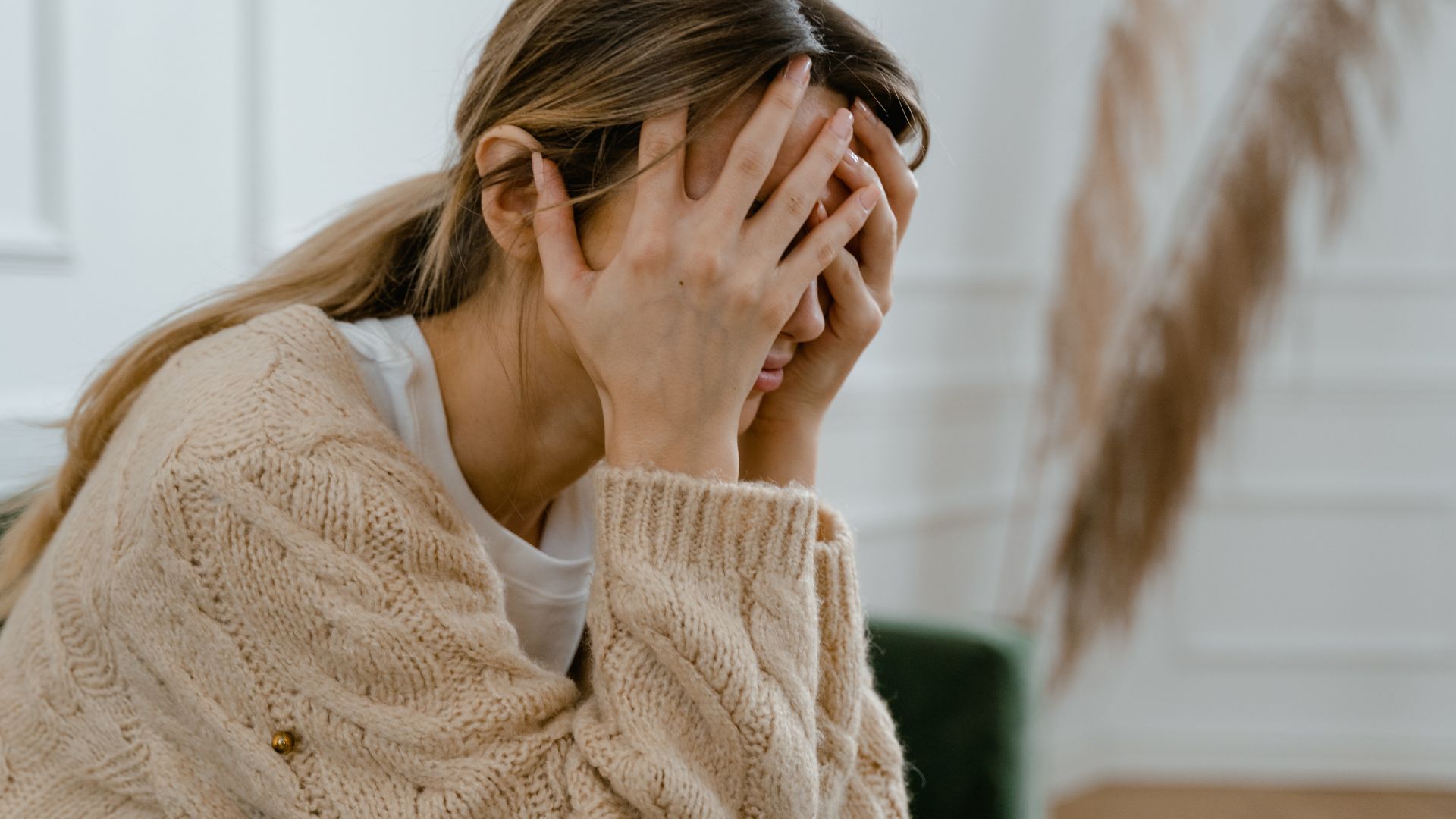 Women in brown sweater stressed