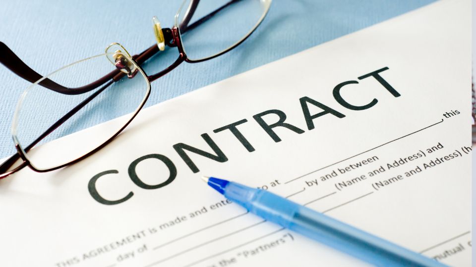 A contract letter with a pen and glasses on top of it
