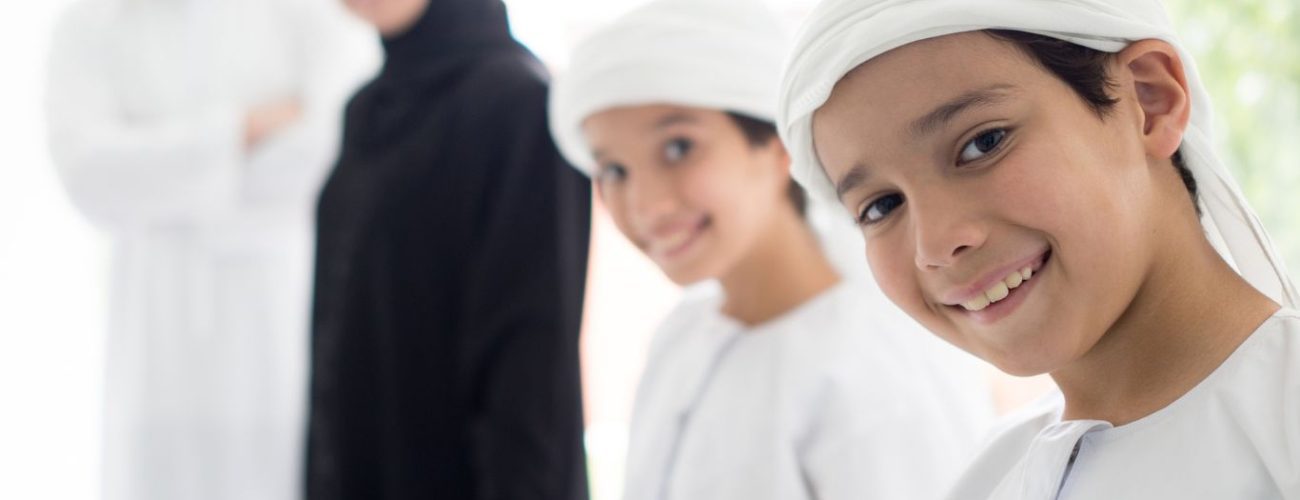 Emirati family smiling together, symbolizing family harmony and protections offered under UAE Family Law reforms.