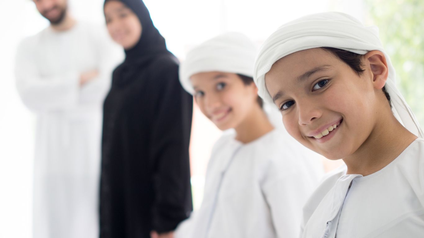 Emirati family smiling together, symbolizing family harmony and protections offered under UAE Family Law reforms.